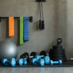 Home gym equipment including free weights, exercise bands, and a jump rope