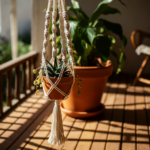 A macrame plant holder hanging on a sunny porch