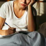 Woman taking notes in bed in the morning